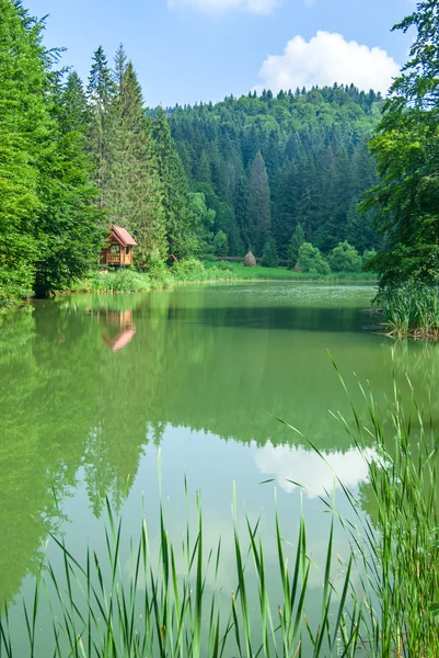 stock image Beautiful wooden house on lake