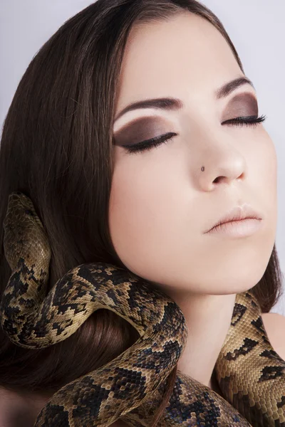 stock image Beautiful brunette girl with a snake