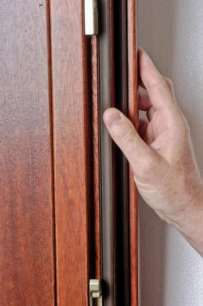 stock image Hand of man works on a window