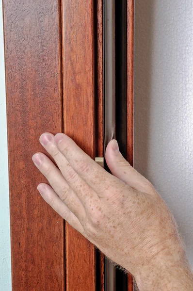 stock image Hand of man works on a window