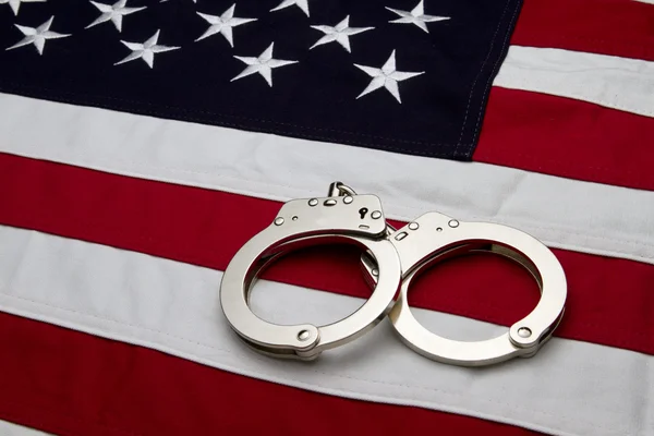 US Flag and Handcuffs Stock Image