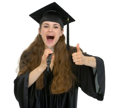 Excited graduation student girl speaking microphone and showing clipart