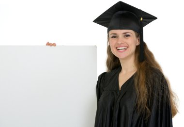 Happy graduation female student holding blank billboard clipart