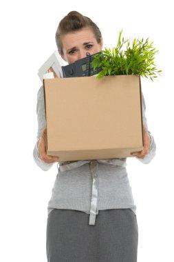 Fired woman employee hiding behind box with personal items clipart