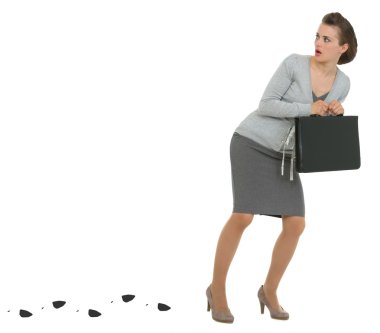 Sneaking business woman with briefcase leaving trace clipart