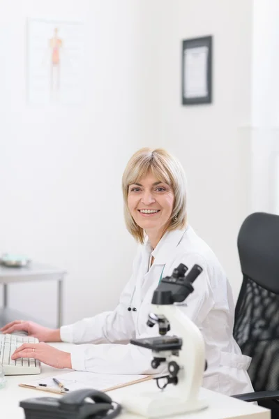 Sorridente donna medico di mezza età che lavora in laboratorio — Foto Stock