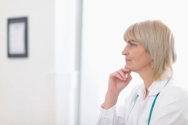 Portrait of middle age doctor woman looking on copy space — Stock Photo, Image