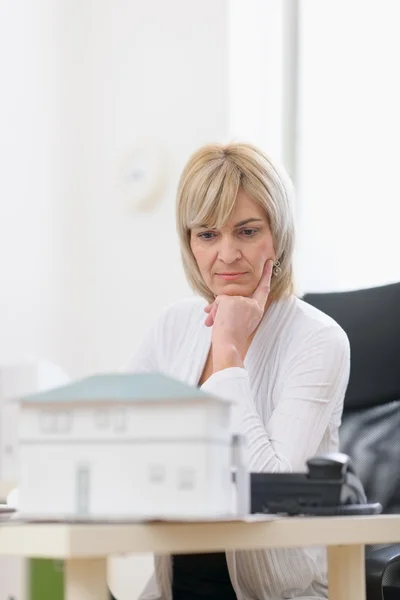 Thoughtful middle age architect woman at work — Stock Photo, Image