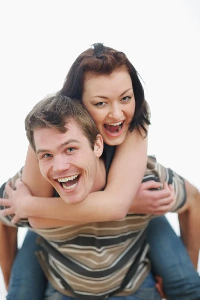 Young woman piggybacking boyfriend — Stock Photo, Image