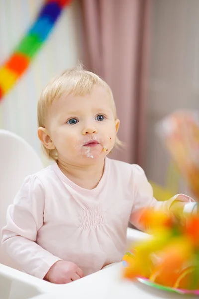 Portrait of thoughtful baby sitting at table — Stock Photo, Image