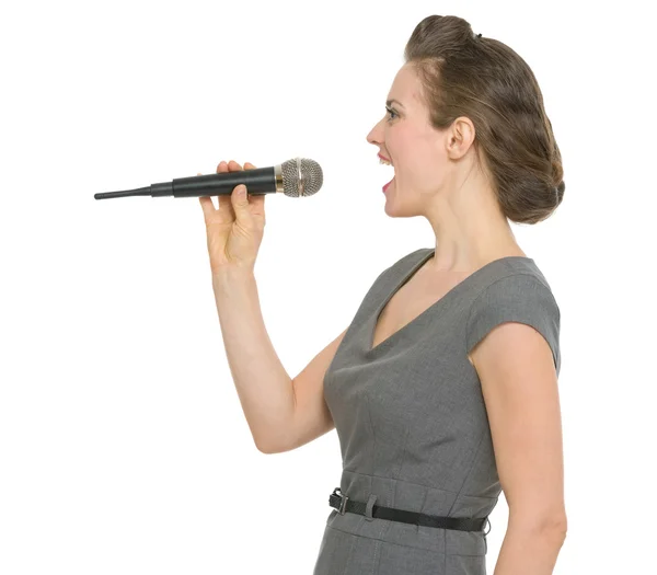 Woman singing in microphone isolated — Stock Photo, Image