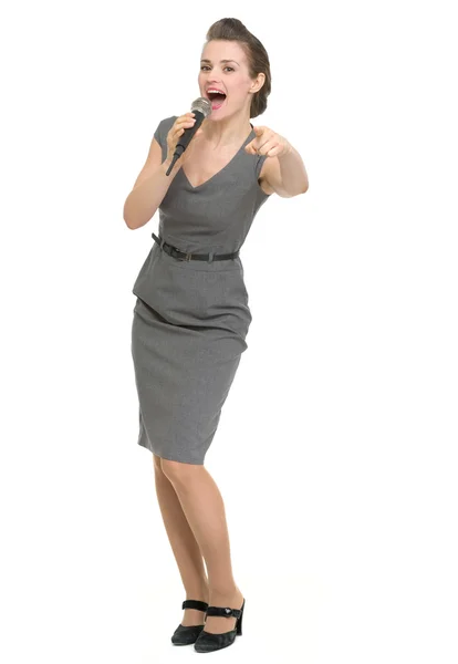 Woman with microphone pointing on you isolated — Stock Photo, Image