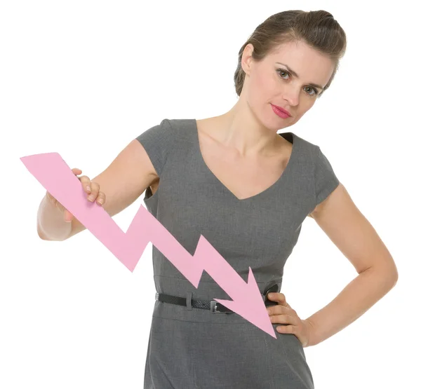 Serious business woman holding decreasing chart arrow isolated — Stock Photo, Image