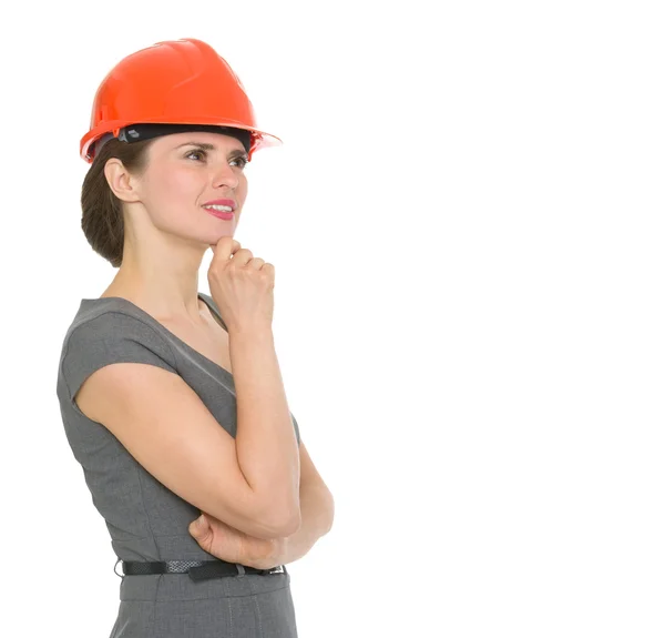 Portrait of dreaming architect woman in helmet looking on copyspace. — Stock Photo, Image
