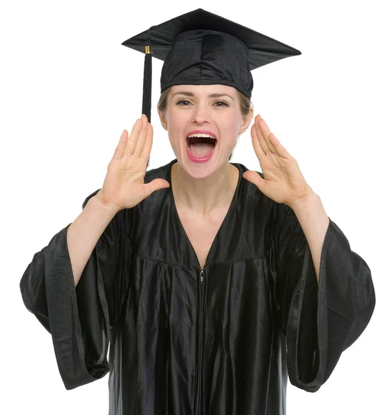 Female graduation student shouting through megaphone shaped hands — Stock Photo, Image