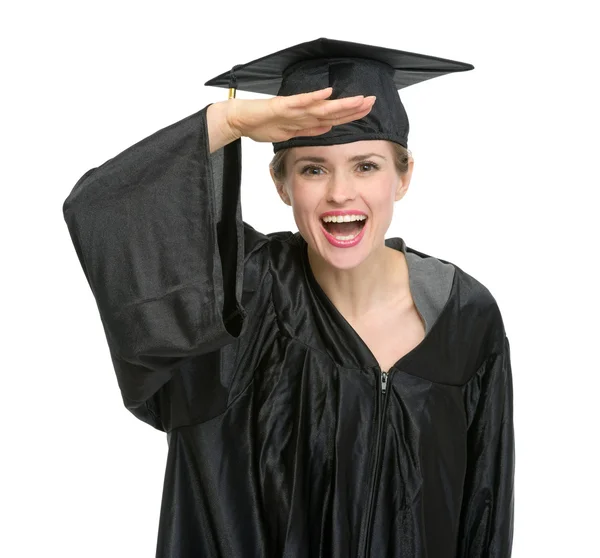 Graduação mulher com mão perto da testa olhando para câmera isolada — Fotografia de Stock