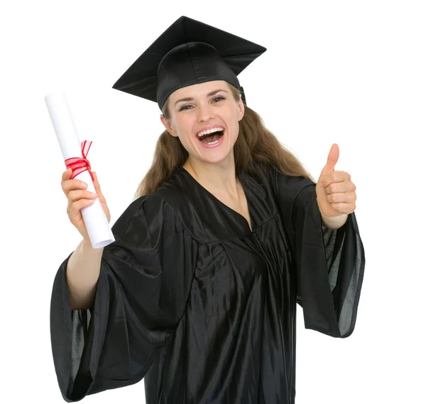 Smiling graduation woman with diploma showing thumbs up — Stock Photo, Image