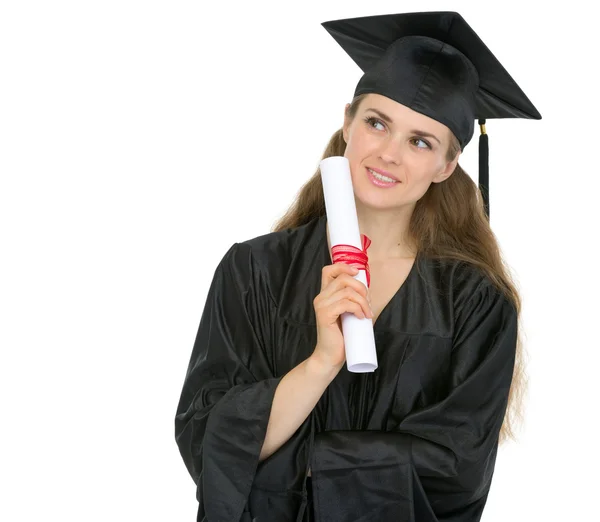 Thoughtful graduation woman with diploma looking on copy space — Stock Photo, Image