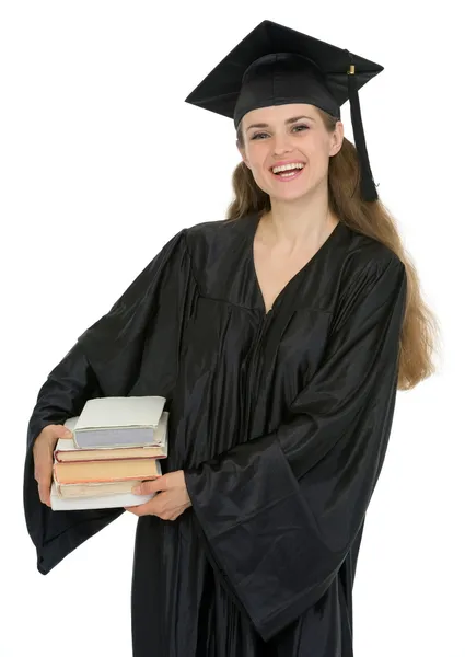 Graduación estudiante femenina sosteniendo pila de libros — Foto de Stock