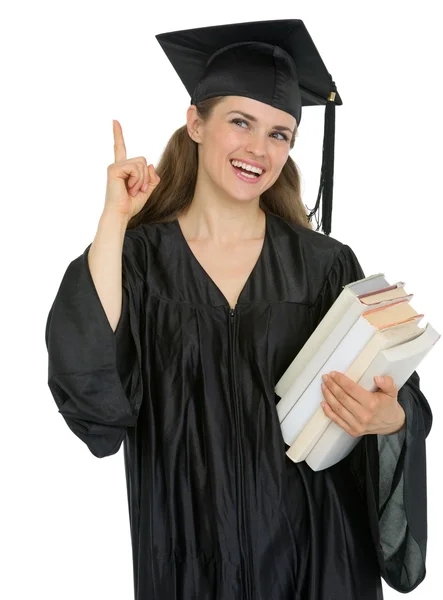 Graduación chica estudiante con pila de libros tiene idea — Foto de Stock