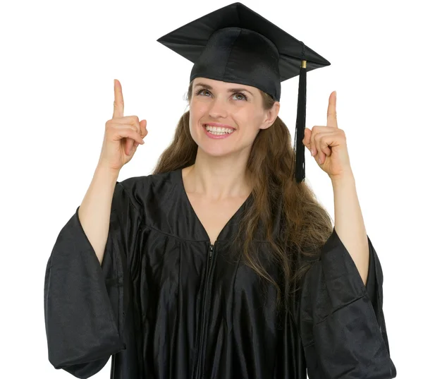 Happy graduation student girl pointing up — Stock Photo, Image