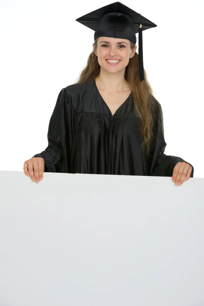 Happy graduation student woman holding blank billboard — Stock Photo, Image