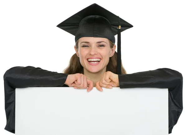 Happy graduation student girl with blank billboard — Stock Photo, Image