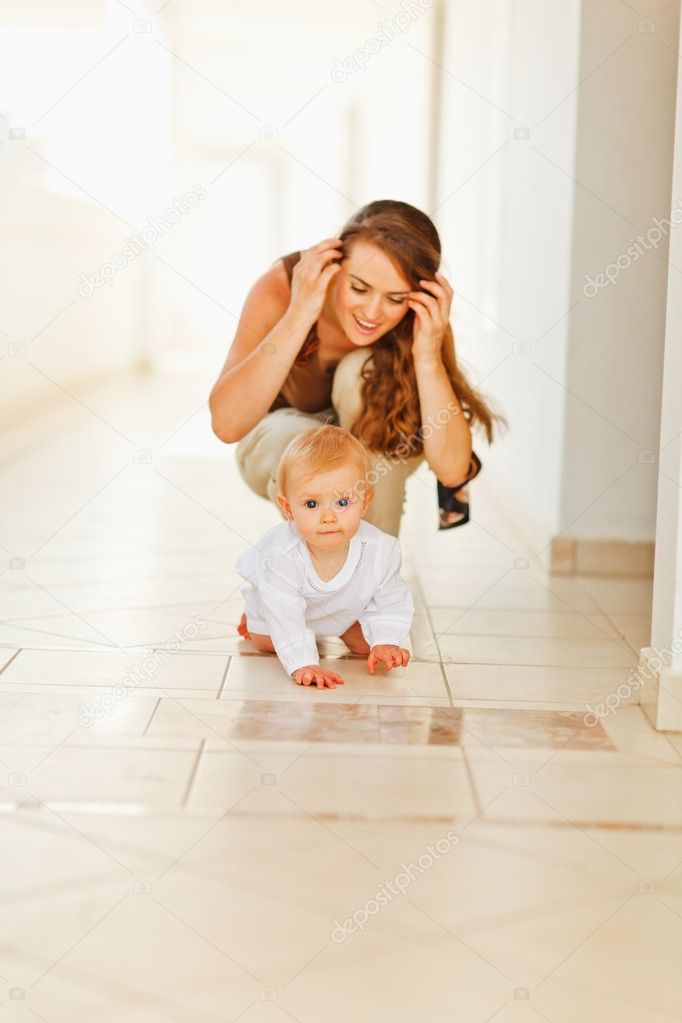 Happy mother playing with baby