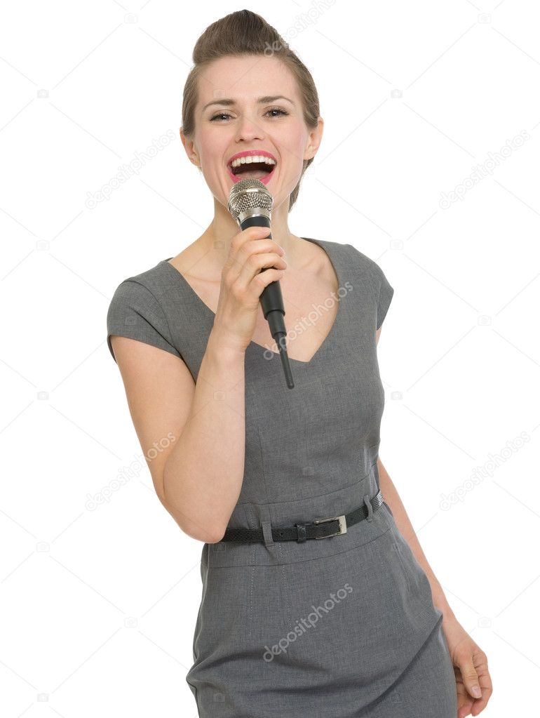 Happy woman singing in microphone isolated