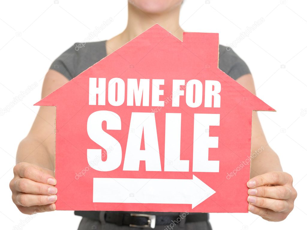 Closeup on home for sale sign in female hand isolated
