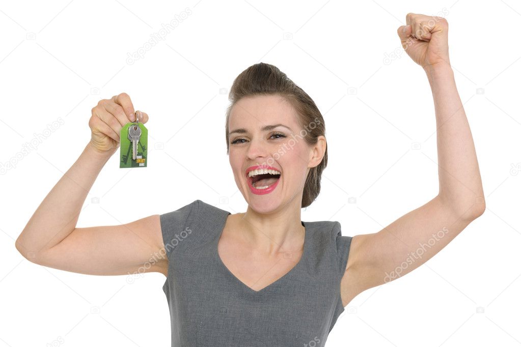 Excited woman showing home keys isolated