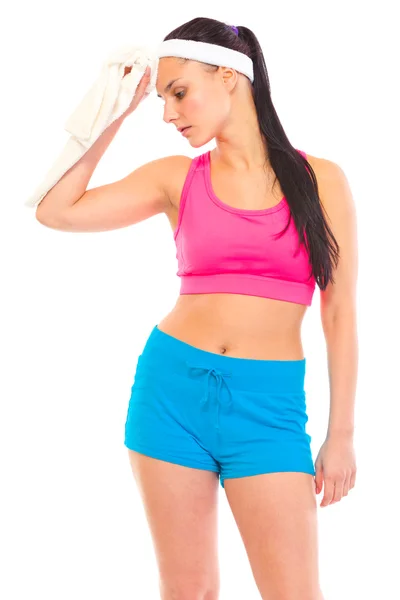 Tired young girl wiping her face with towel after exercising — Stock Photo, Image