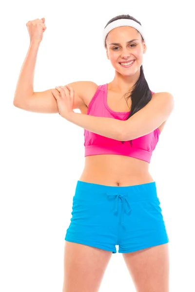Cheerful fitness young girl in sportswear showing her muscles — Stock Photo, Image