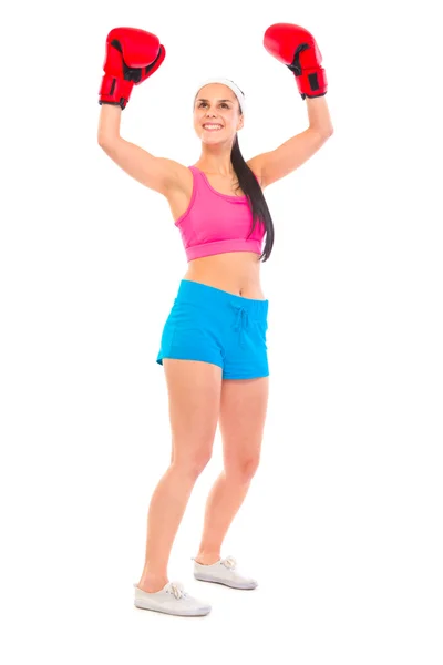 Pleased young fit girl in boxing gloves holding hands raised up — Stock Photo, Image