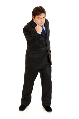 Full length portrait of angry businessman threaten with fist clipart