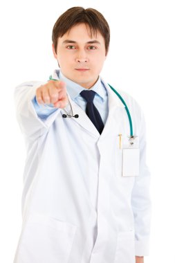 Confident young medical doctor pointing finger at you clipart