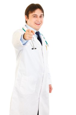 Smiling young medical doctor pointing finger at you clipart