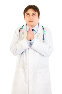 Young medical doctor praying for success clipart