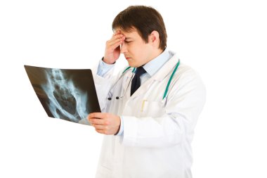 Concentrated medical doctor holding results of pelvis roentgen clipart