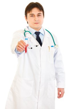 Concentrated medical doctor holding blood sample in hand