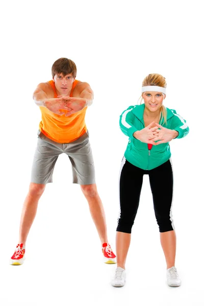 Genç kadın ve erkek spor giyim isol egzersiz spor yapma içinde uygun — Stok fotoğraf