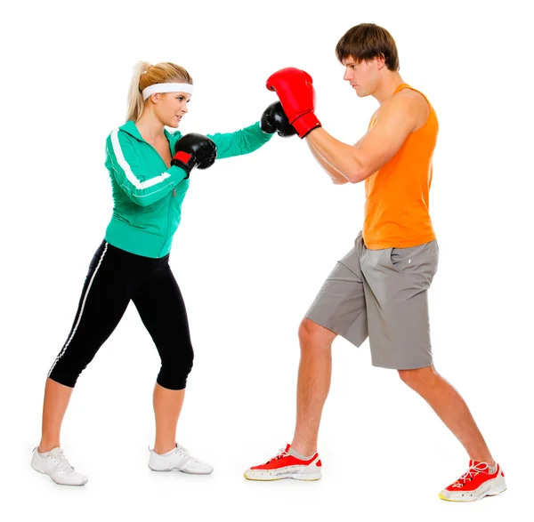 Young woman and man in boxing gloves practicing isolated on whit