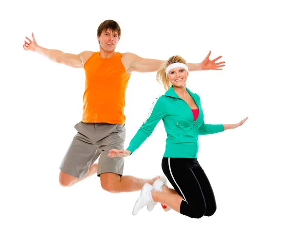 Fitness meisje en man in sportkleding springen geïsoleerd op wit — Stockfoto