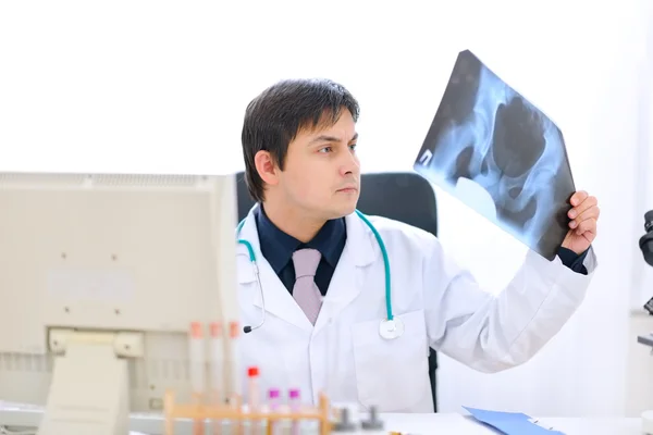 Medical doctor sitting at office table and analyzing patients ro — Stock Photo, Image