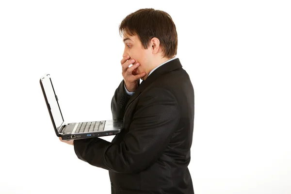 Shocked modern businessman looking in laptops screen — Stock Photo, Image