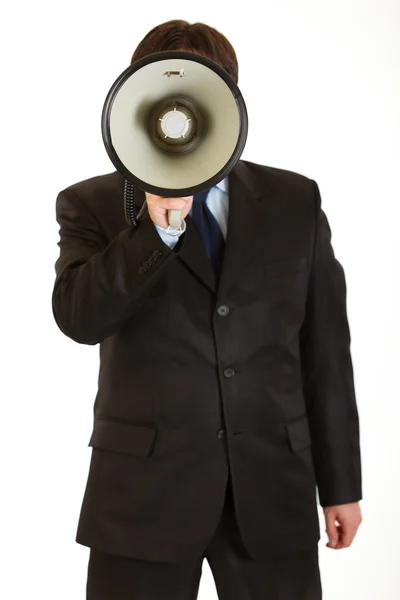 Businessman standing in front of camera and speaking into megaphone — Stock Photo, Image
