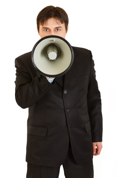 Serious modern businessman speaking into megaphone