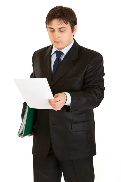 Serious modern businessman with folder in hand exploring document — Stock Photo, Image