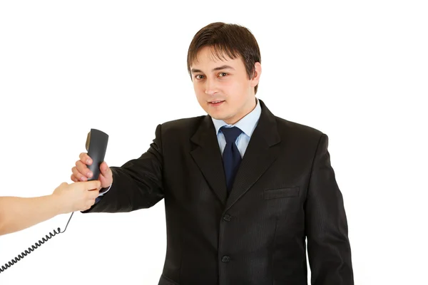 Smiling young businessman taking phone from secretary — Stock Photo, Image