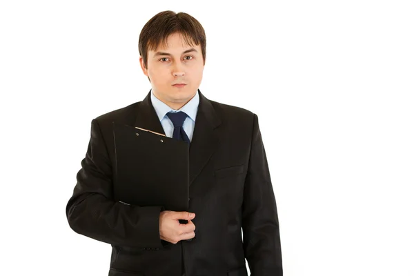 Concentrated businessman holding clipboard in hand — Stock Photo, Image